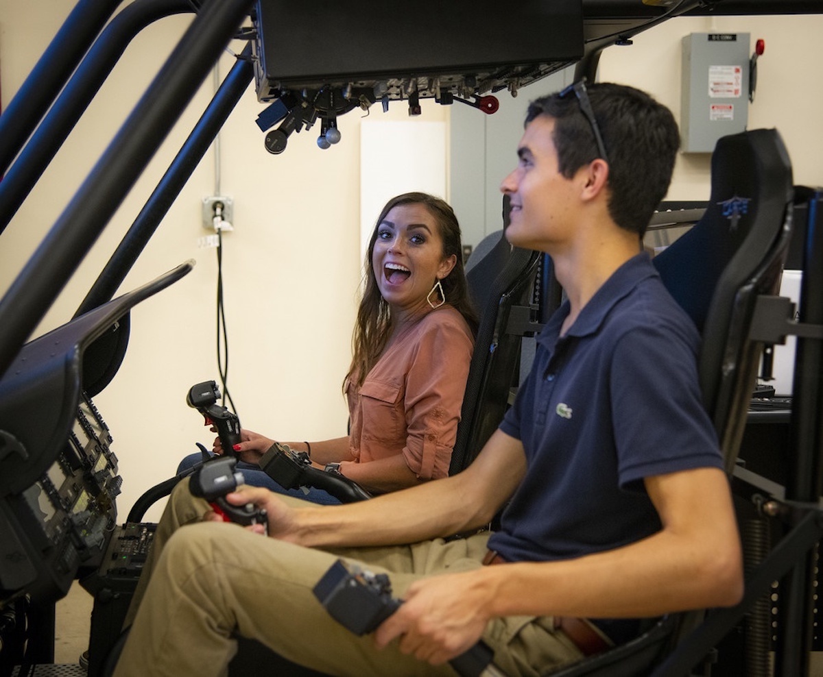 two interns at controls of a grounded helicopter