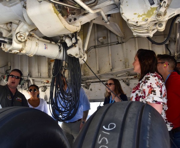 inspecting the landing gear of an Air Force transport plane